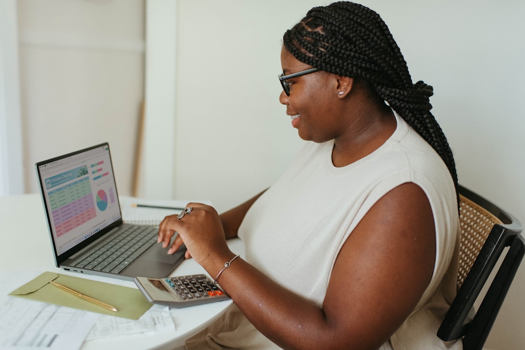a-person-sitting-at-a-table-using-a-laptop-computer-d3nknw1ildm