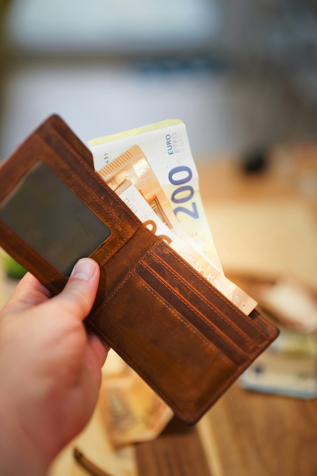 hand holding wallet cash money banknotes